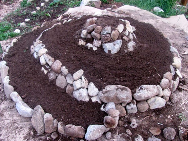 Herb Spiral in progress with mounded dirt to increase growing space.