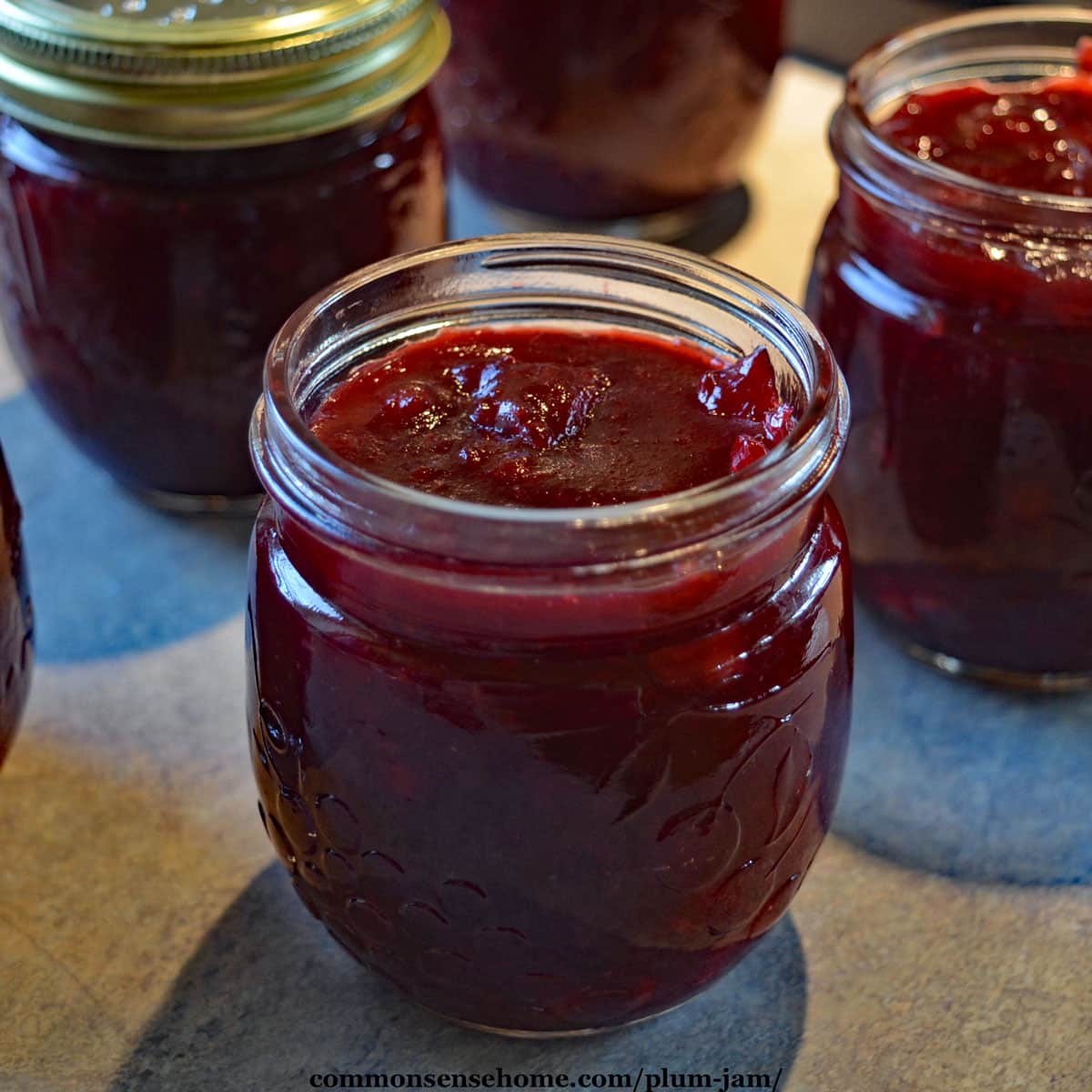 jars of plum jam on counter