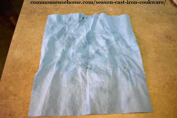 shop towel with excess oil removed during cast iron seasoning