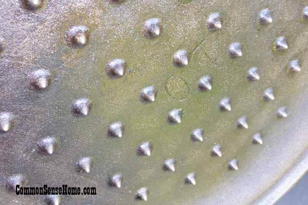 underside of cast iron Dutch oven lid with spikes