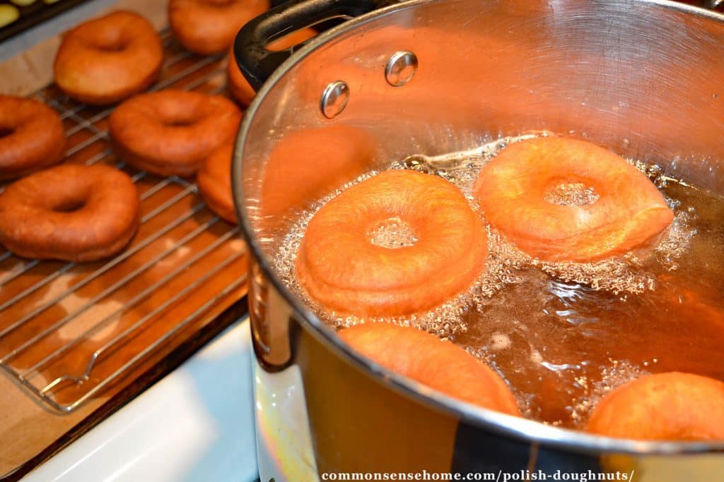 Homemade doughnuts frying and cooling