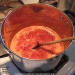 stockpot filled with strawberry jam with pectin, sitting on the stove