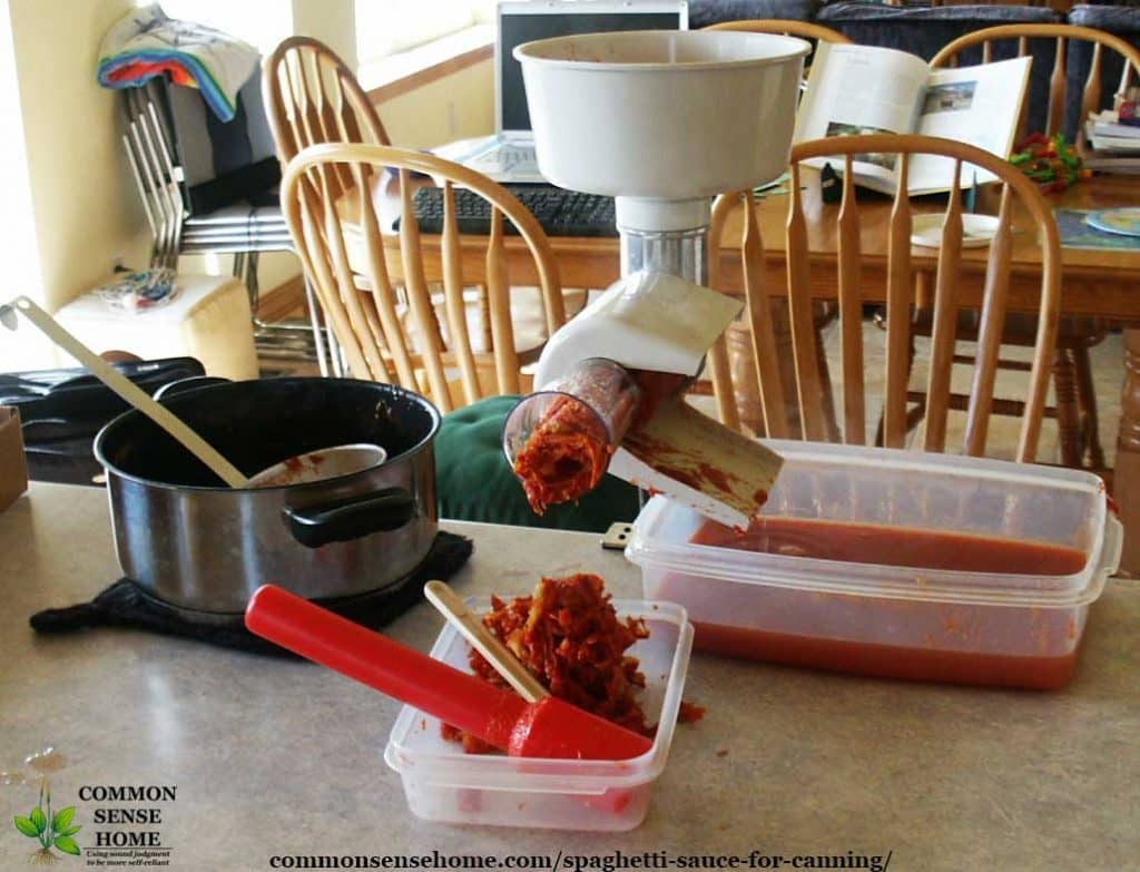 Food strainer being used to make tomato sauce