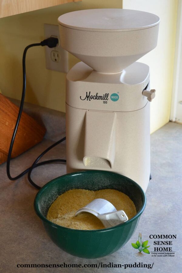 mockmill grain mill with bowl of fresh ground cornmeal