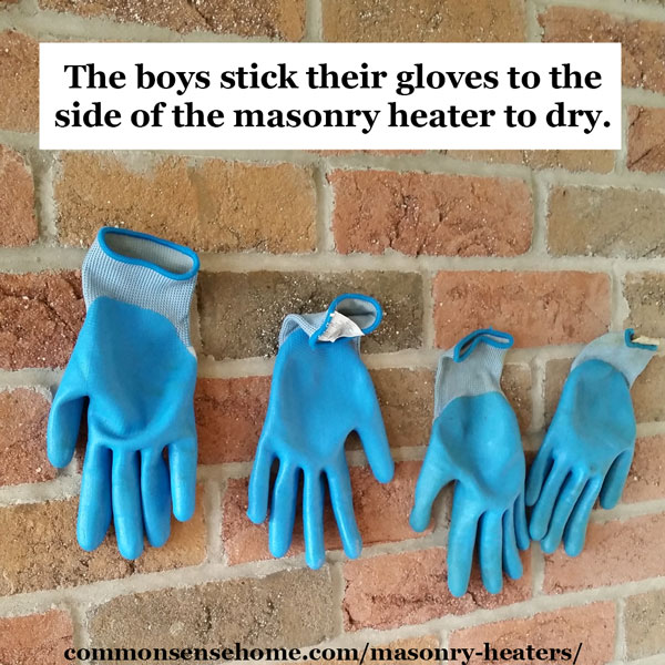 The side of the masonry stove doubles as a glove drying rack.