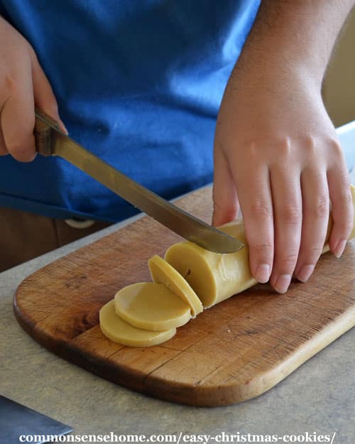 Slicing cookies dough for lemon almond cookies