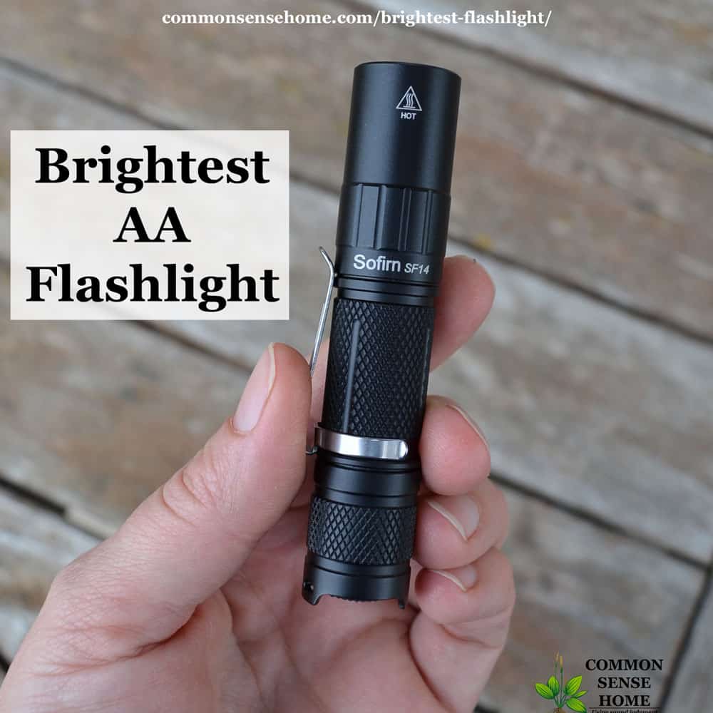 brightest AA flashlight - small black flashlight being held in hand