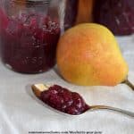 spoonful of blueberry pear jam with pear and jar of jam