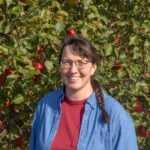 Laurie Neverman near apple tree