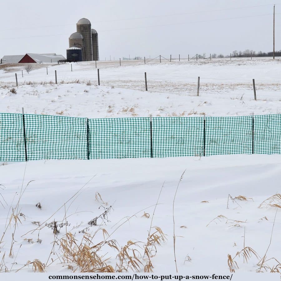 green snow fence surrounded by snow