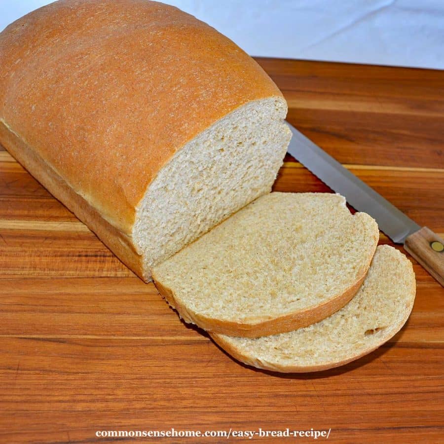 easy bread recipe - loaf of bread with two slices cut off on cutting board