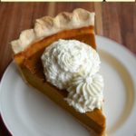 slice of homemade pumpkin pie with whipped cream