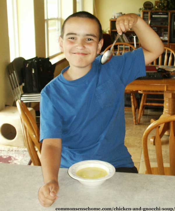 happy boy eating homemade soup