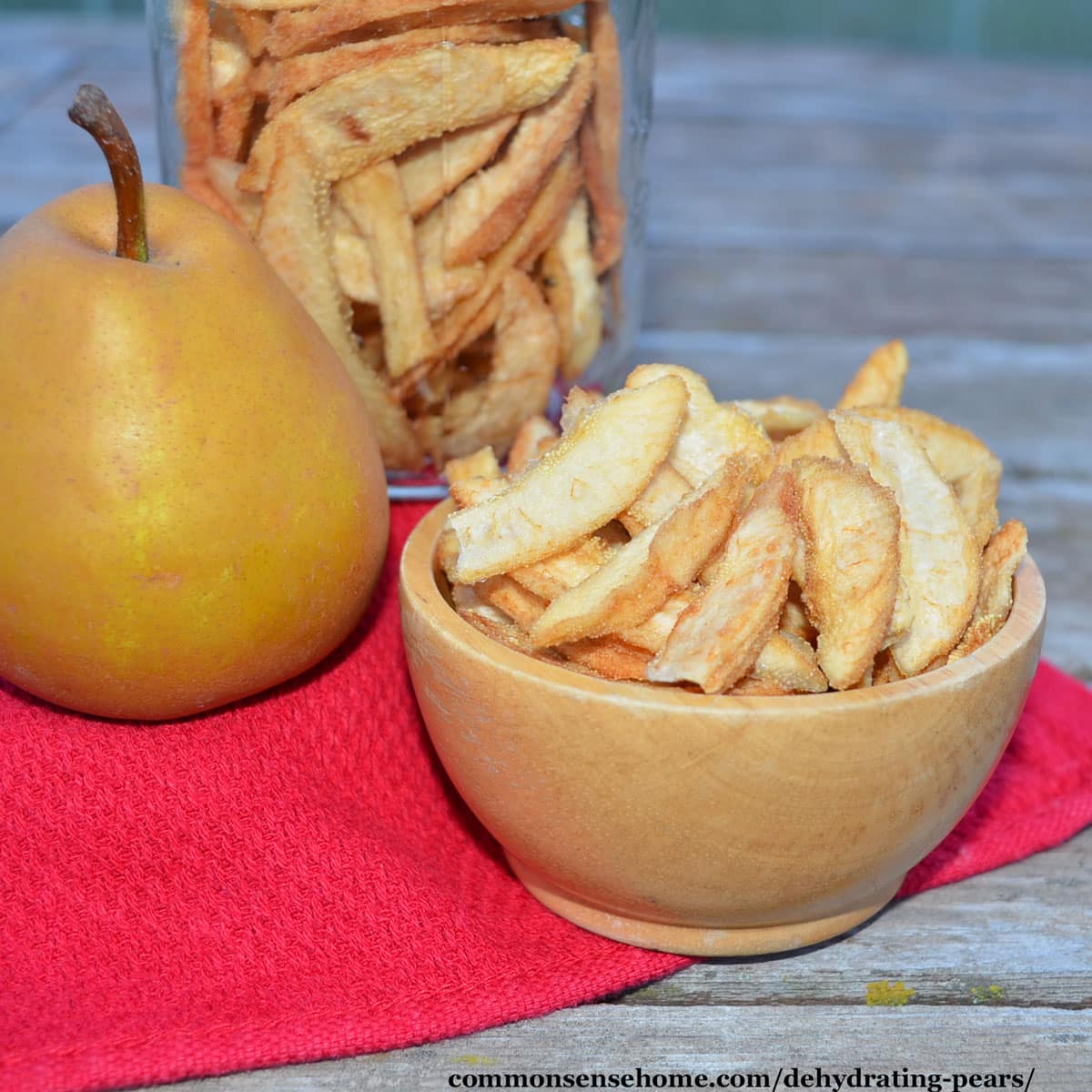 fresh pear and bowl of dehydrated pears