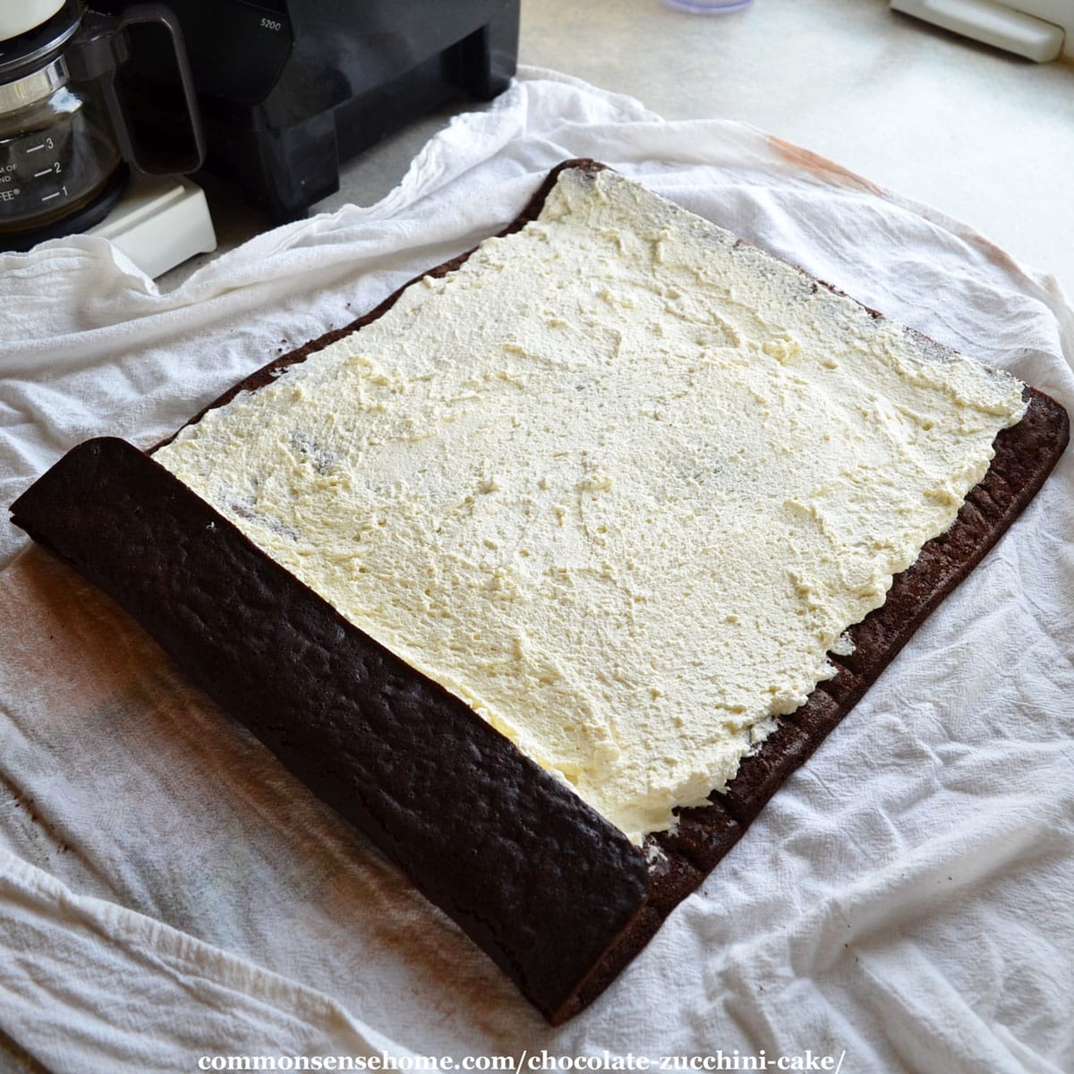 filling the chocolate zucchini cake with sweetened whipped cream