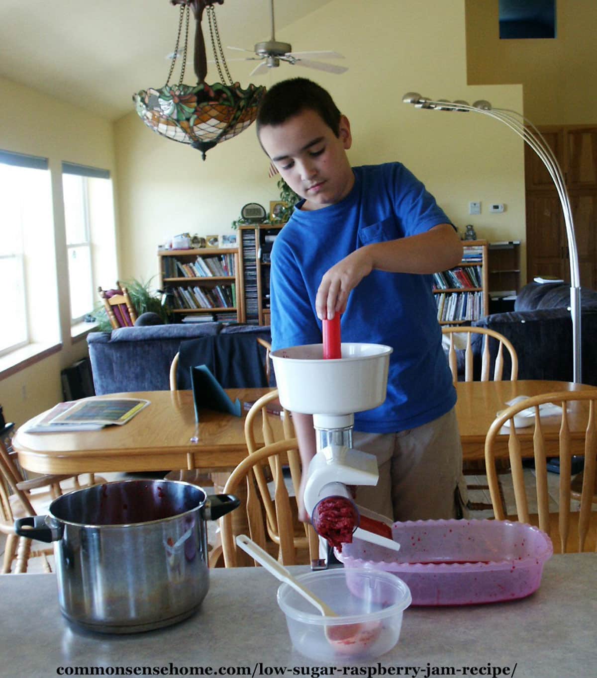 straining raspberries for jam