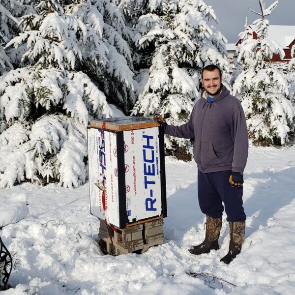 Duncan next to insulated beehive