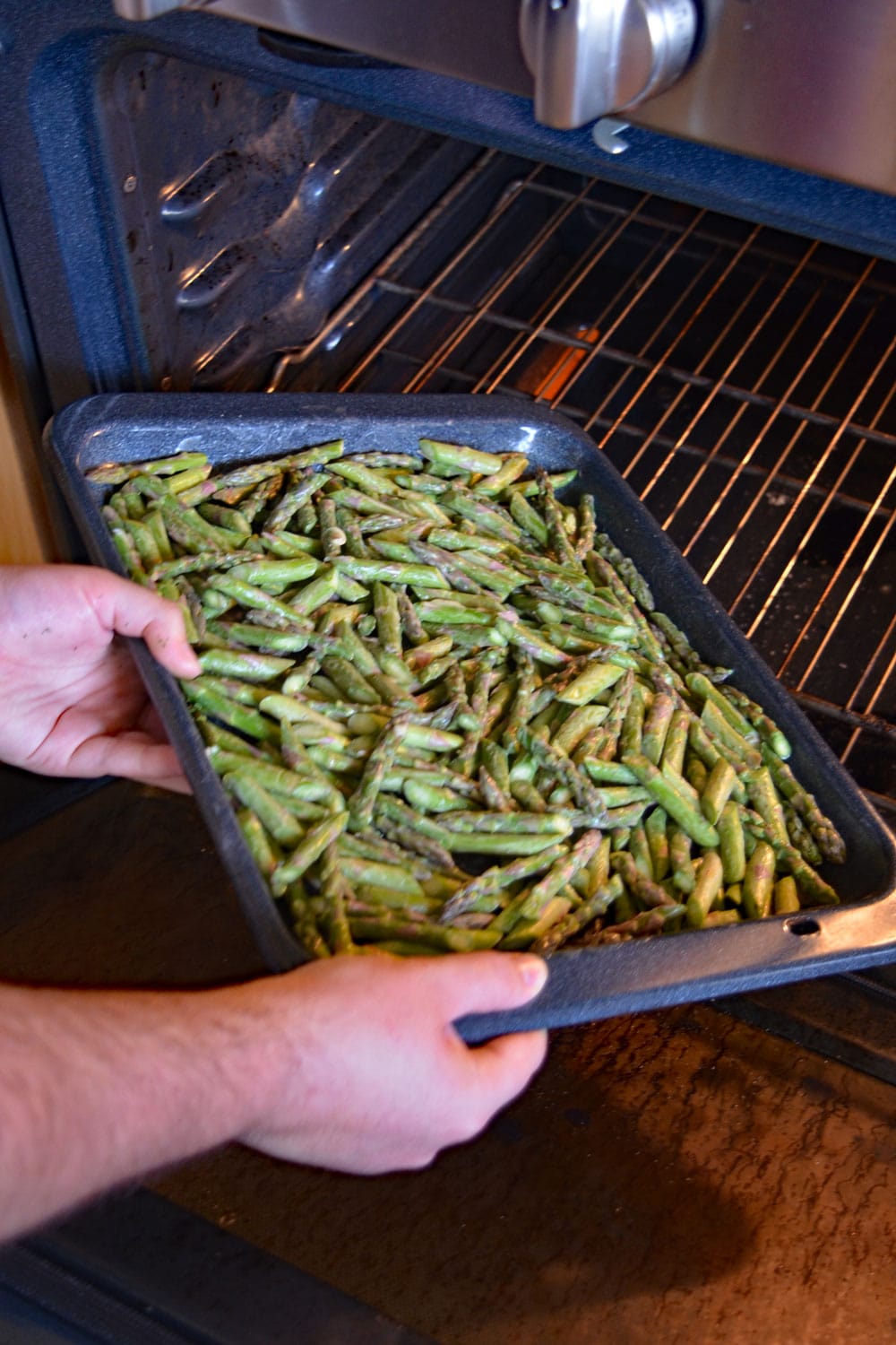 placing asparagus in the oven