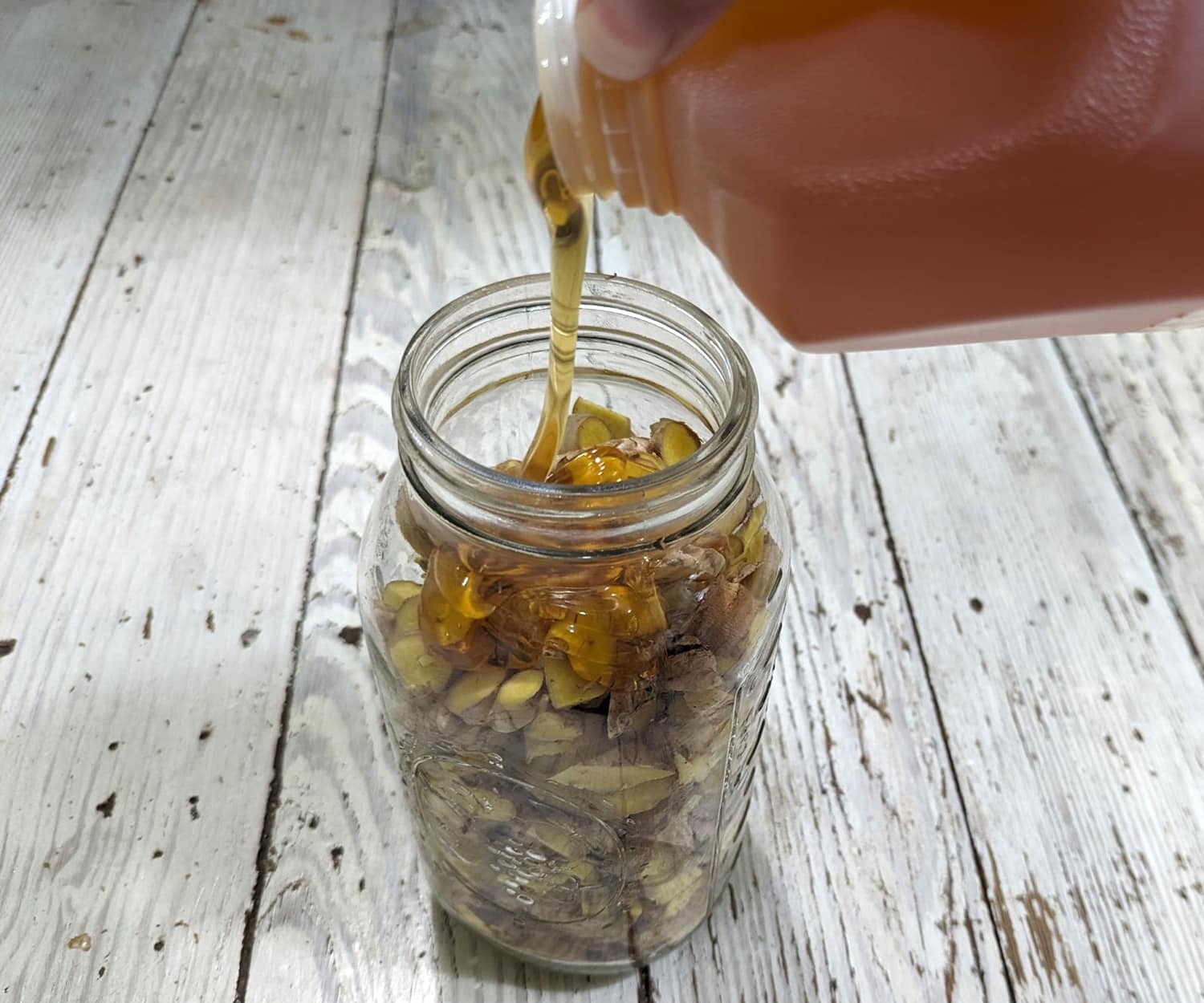 pouring honey over ginger