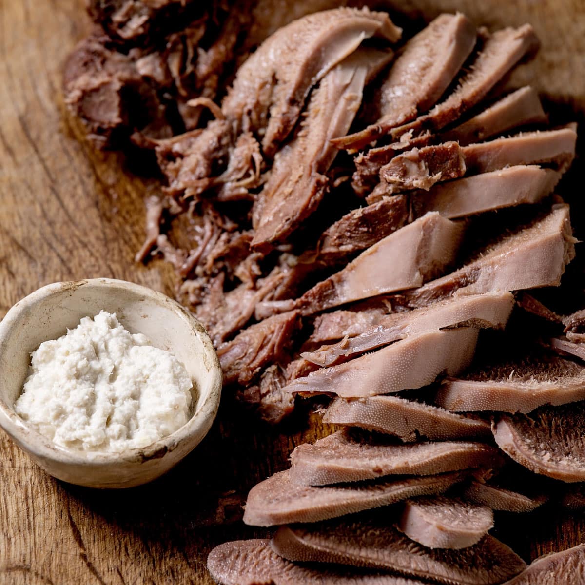 https://commonsensehome.com/wp-content/uploads/2023/10/sliced-cow-tongue-with-horseradish.jpg