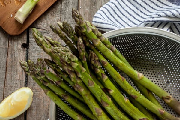 fresh asparagus in colander