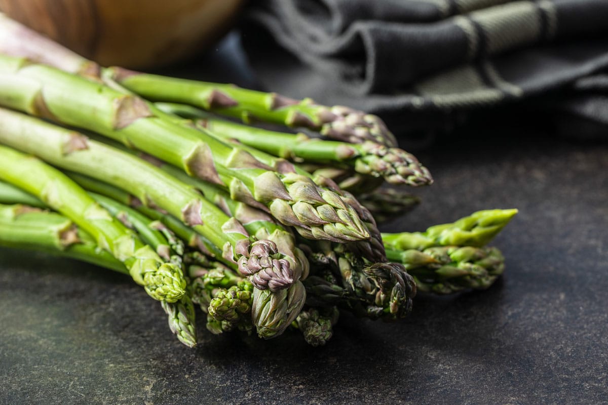 bundle of fresh asparagus on counter