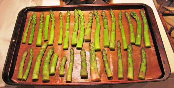 single layer of asparagus on baking sheet