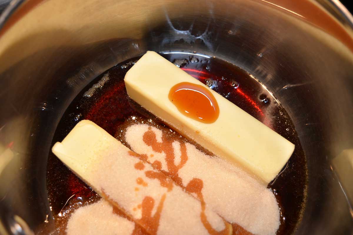 Melting butter, sugar, and maple syrup in a sauce pan.