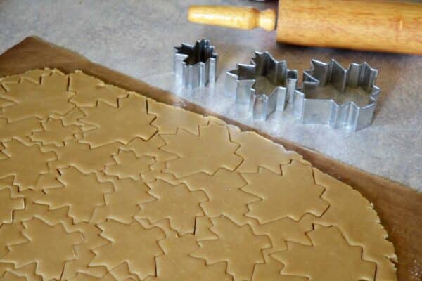 cutting out maple leaf shaped cookies