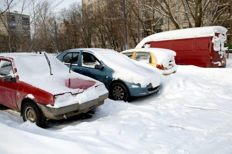 parked vehicles covered in snow