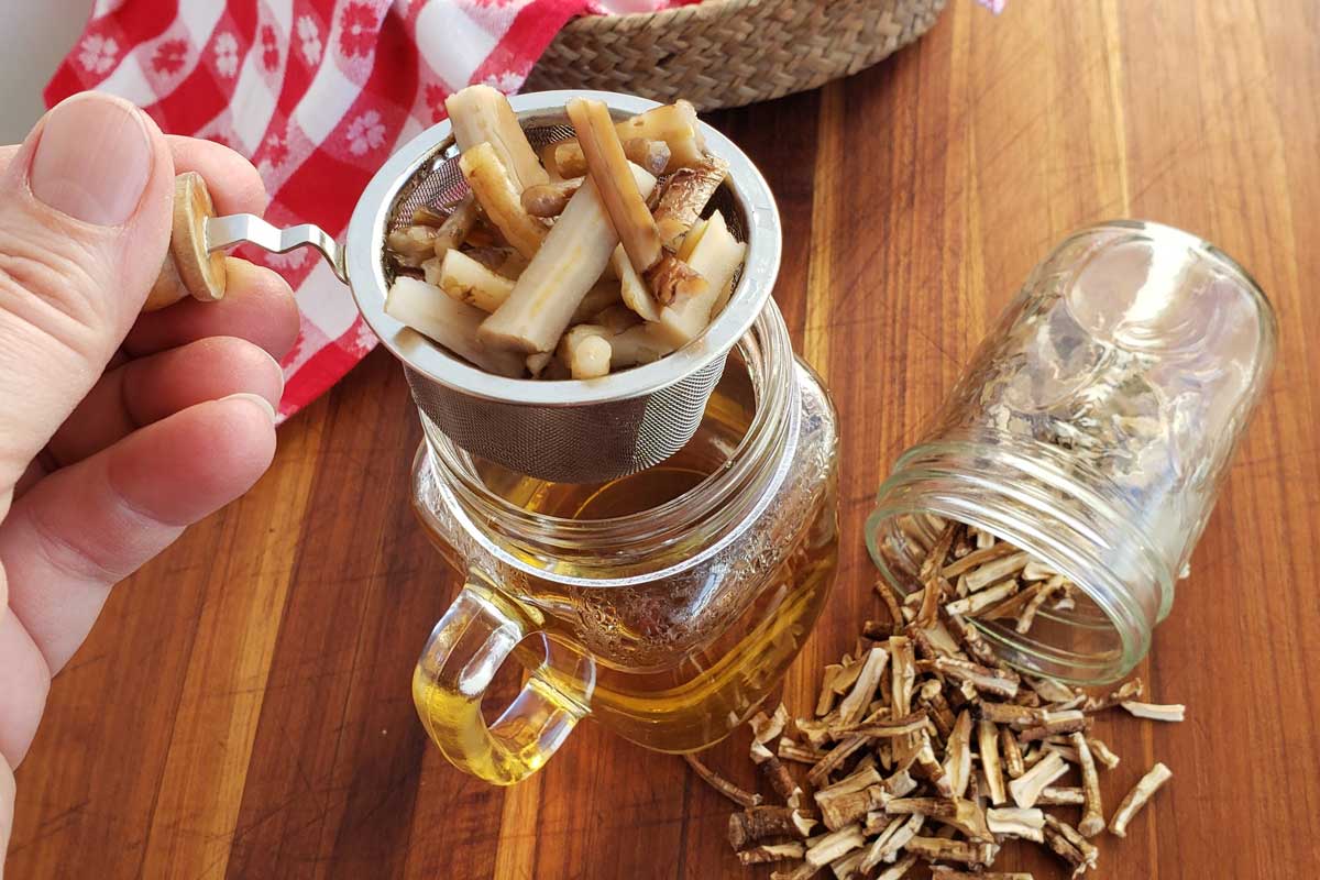 straining dandelion root tea