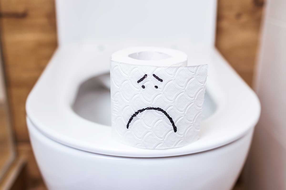 sad face toilet paper on toilet