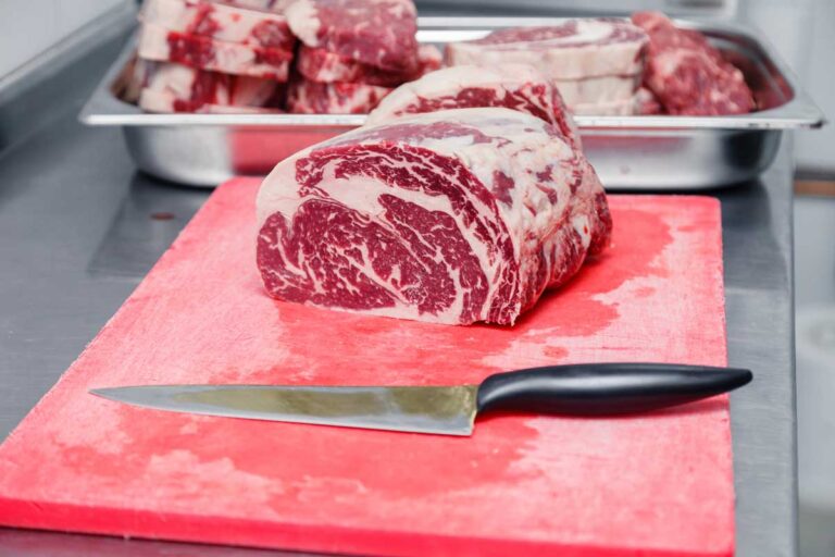 meat on plastic cutting board