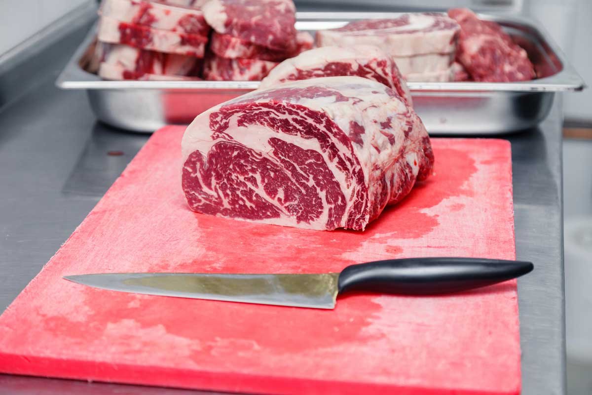 meat on plastic cutting board