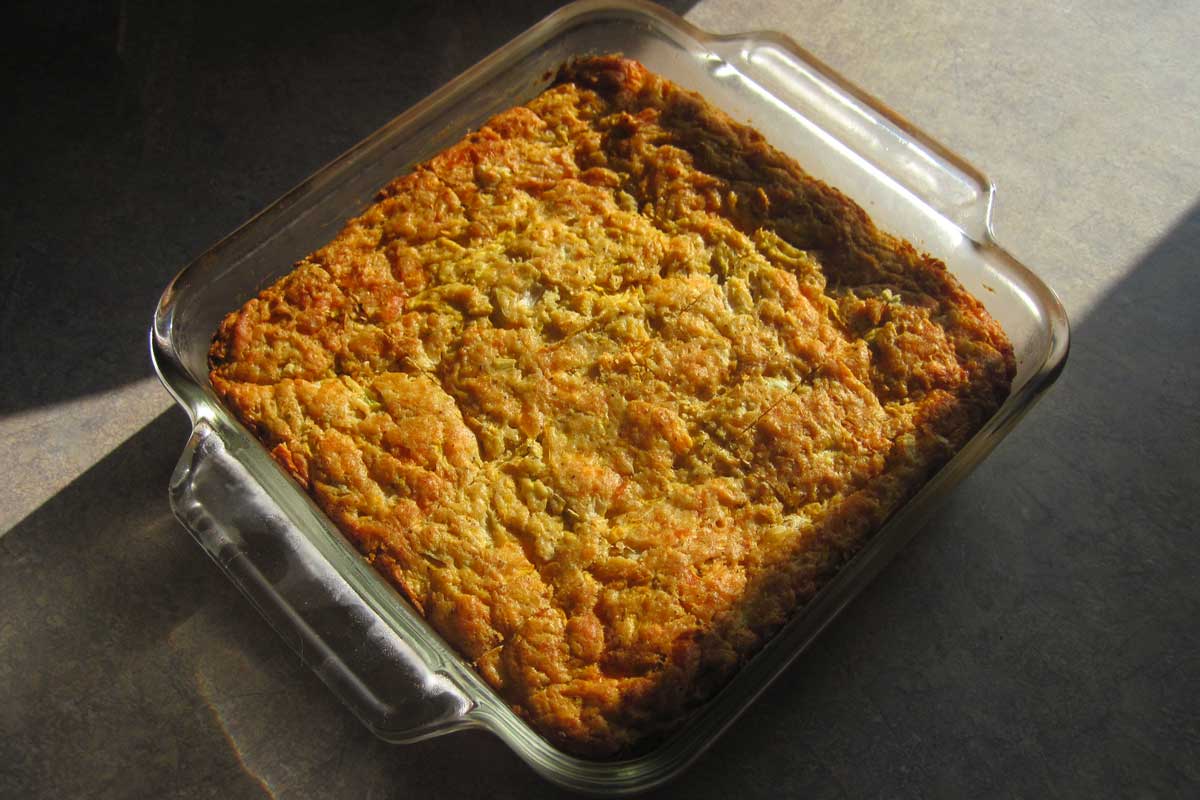 cheesy garlic zucchini bread in a 9x9 glass pan