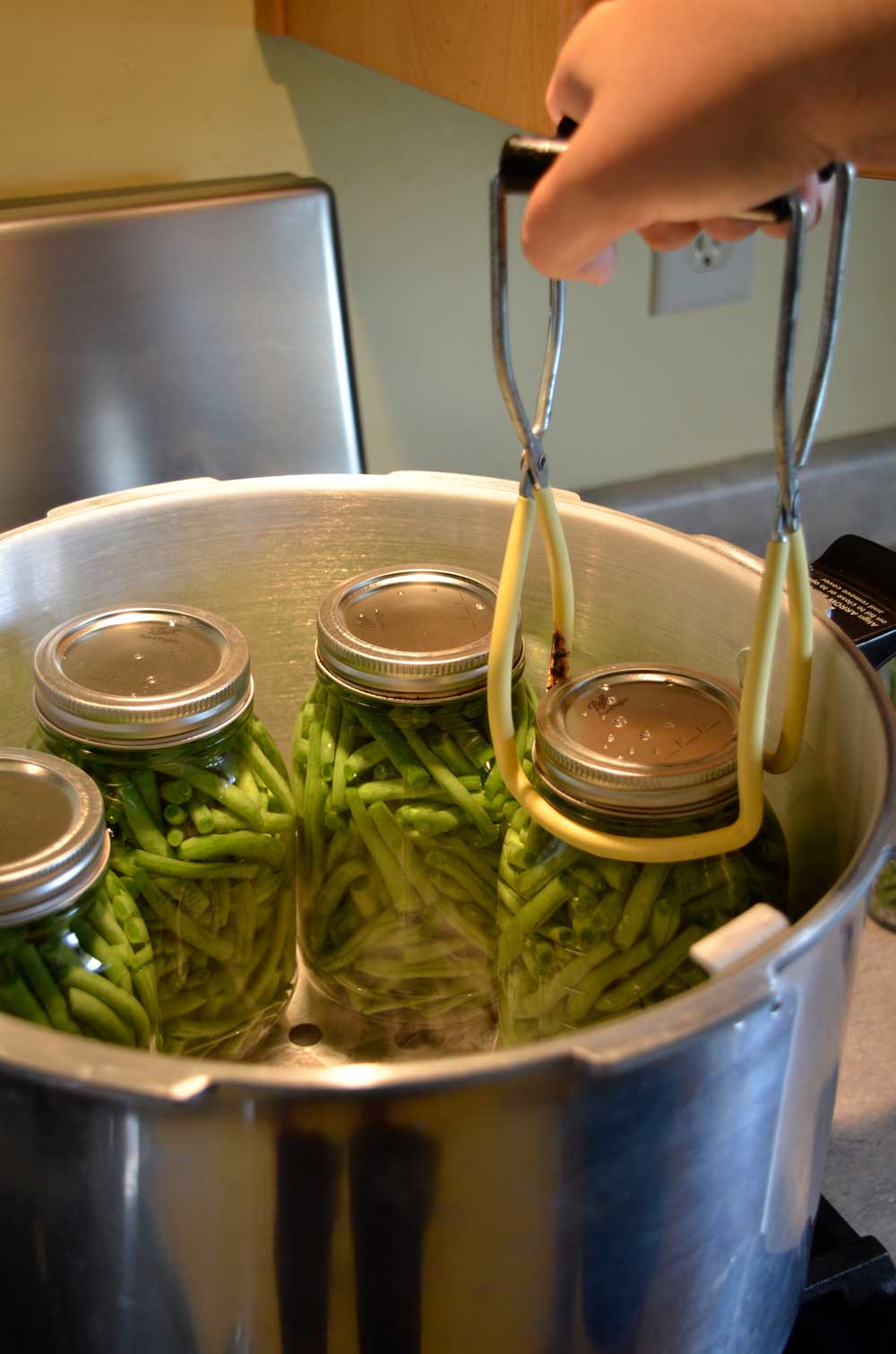 removing jars of beans from pressure canner