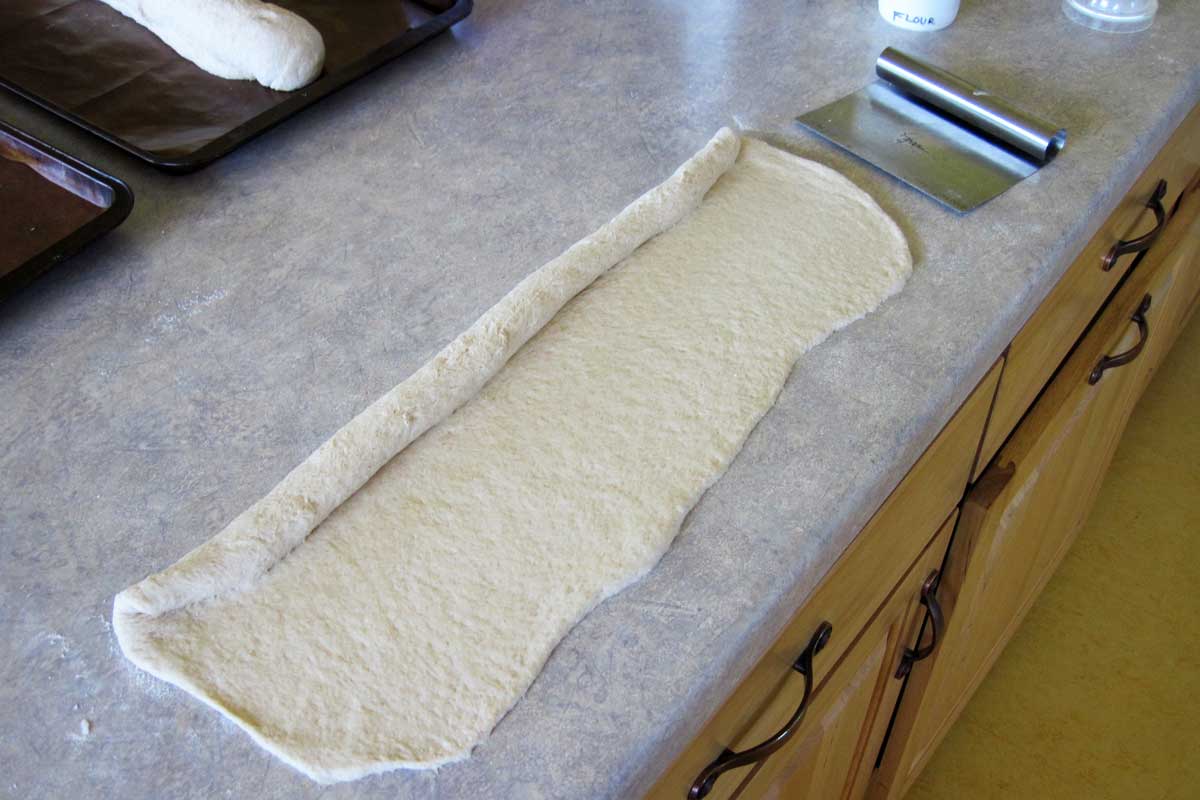 rolling out French bread dough