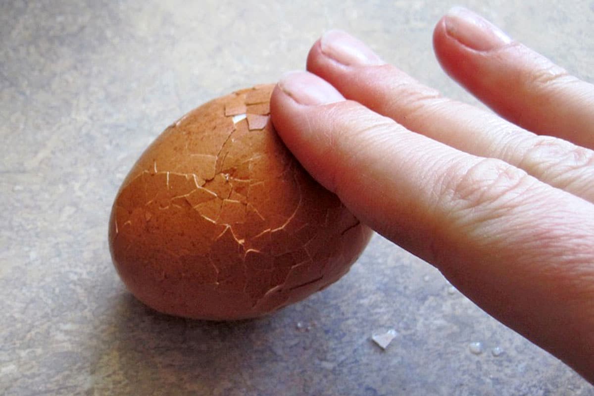 rolling a boiled egg to loosen the shell