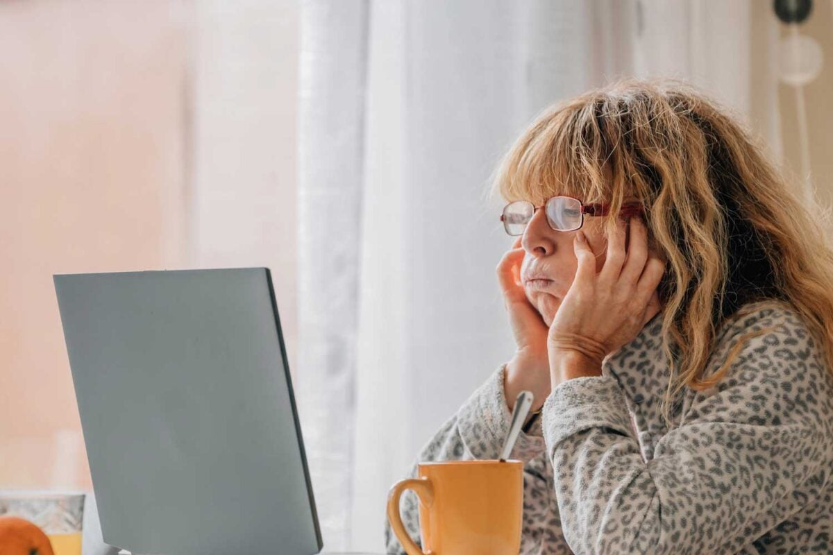 anxious woman looking at laptop